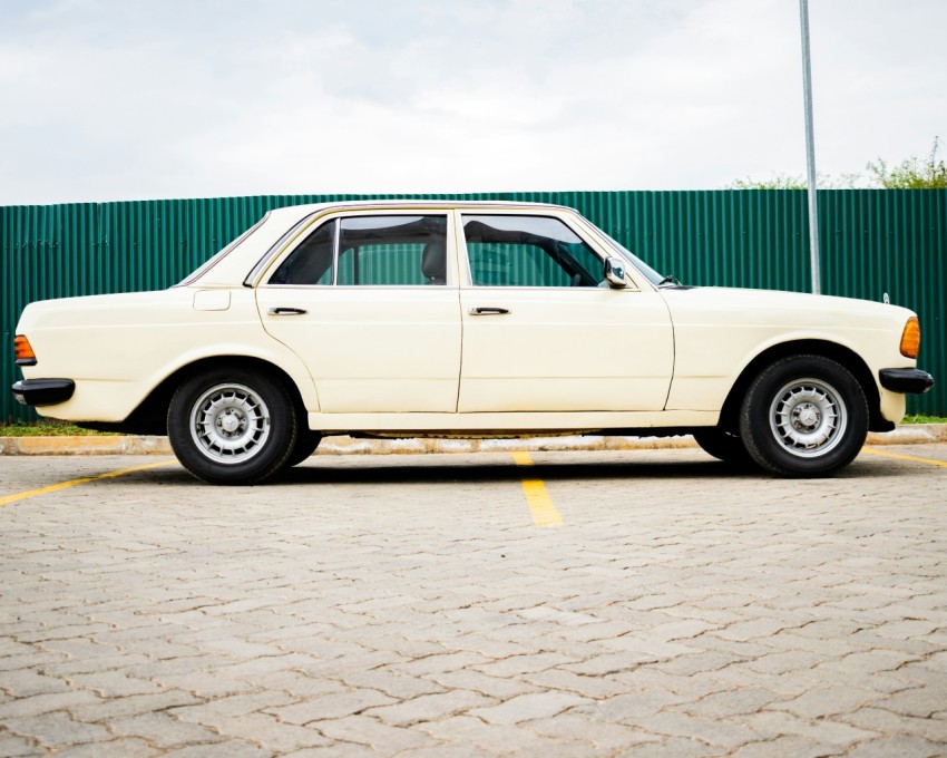 white sedan parked on gray pavement during daytime
