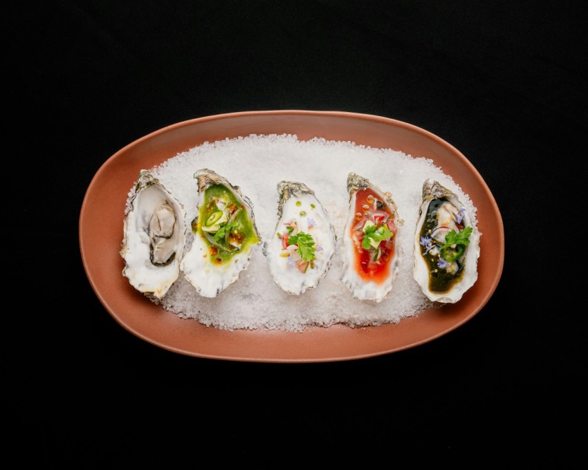 a plate of oysters on a bed of ice