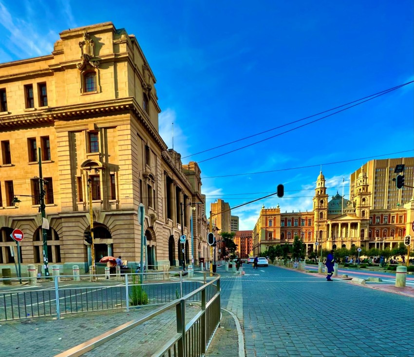 a city street lined with tall buildings and traffic lights