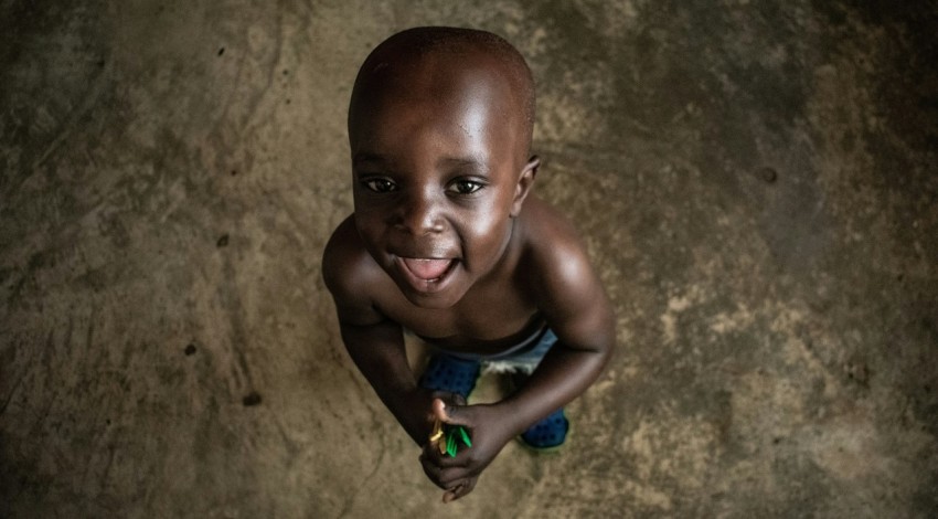 a young boy with a toothbrush in his hand