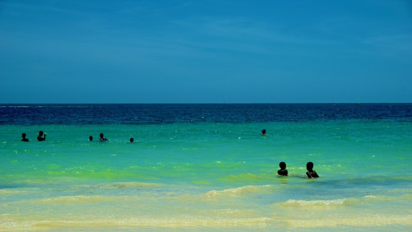 a group of people swimming in the ocean h3PM