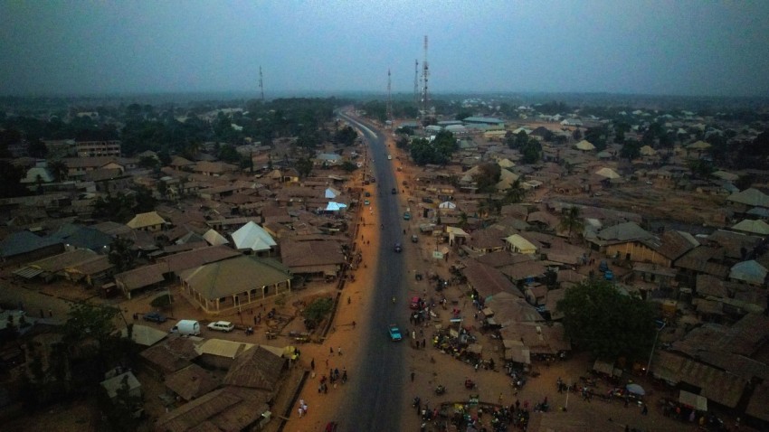 an aerial view of a village and a road