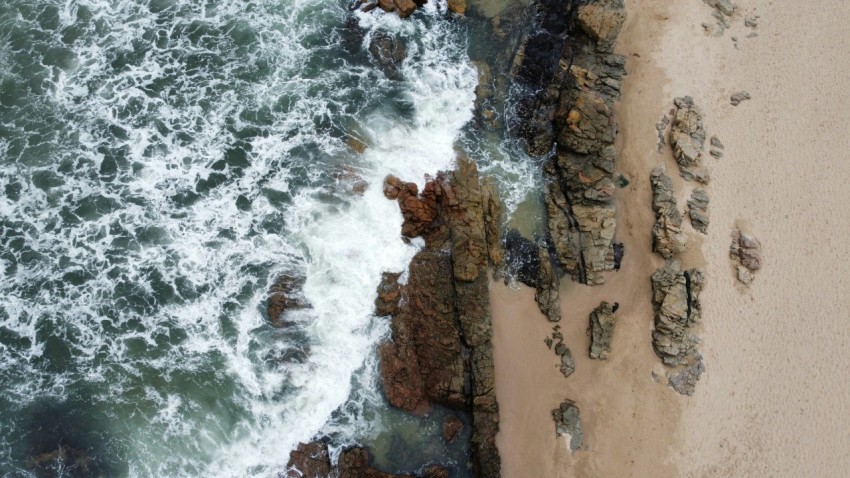a birds eye view of a beach and ocean