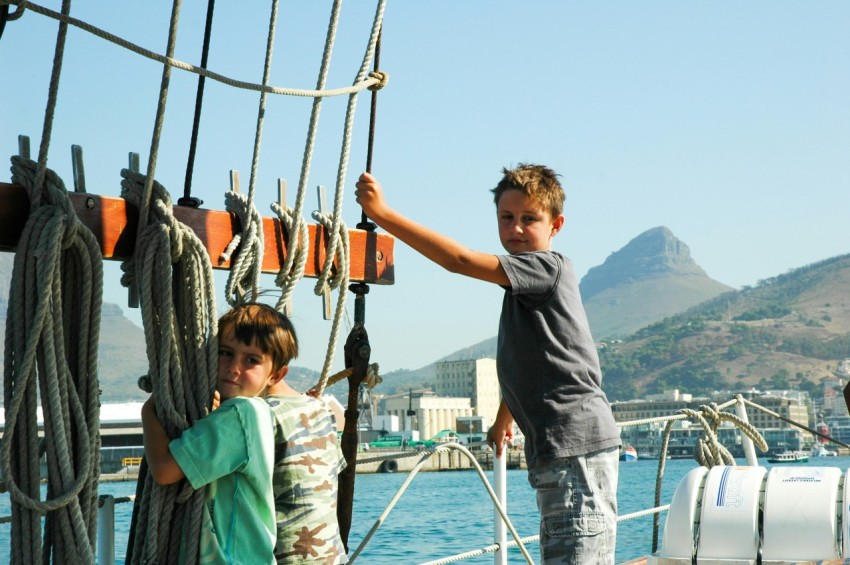man in black crew neck t shirt standing beside girl in green jacket during daytime