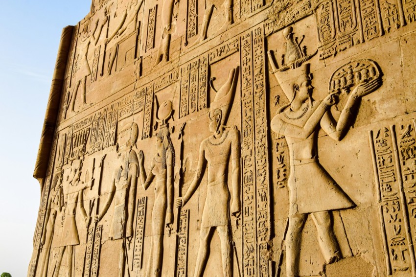 a large wall with a bunch of egyptian art on it