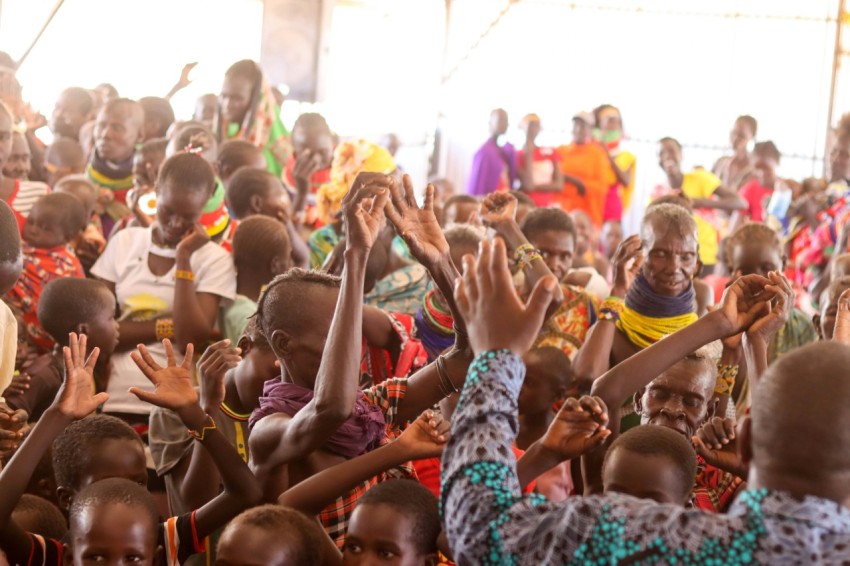 a large group of people standing around each other