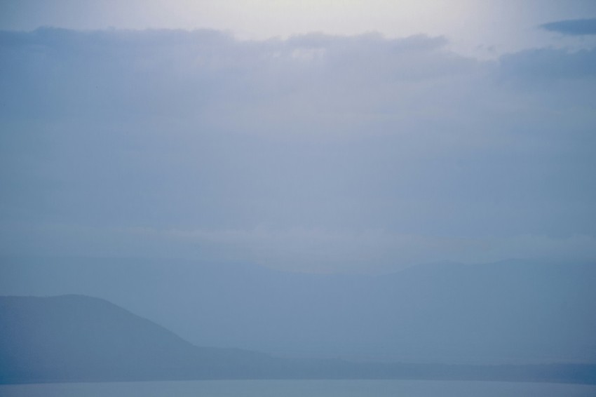 a large body of water under a cloudy sky