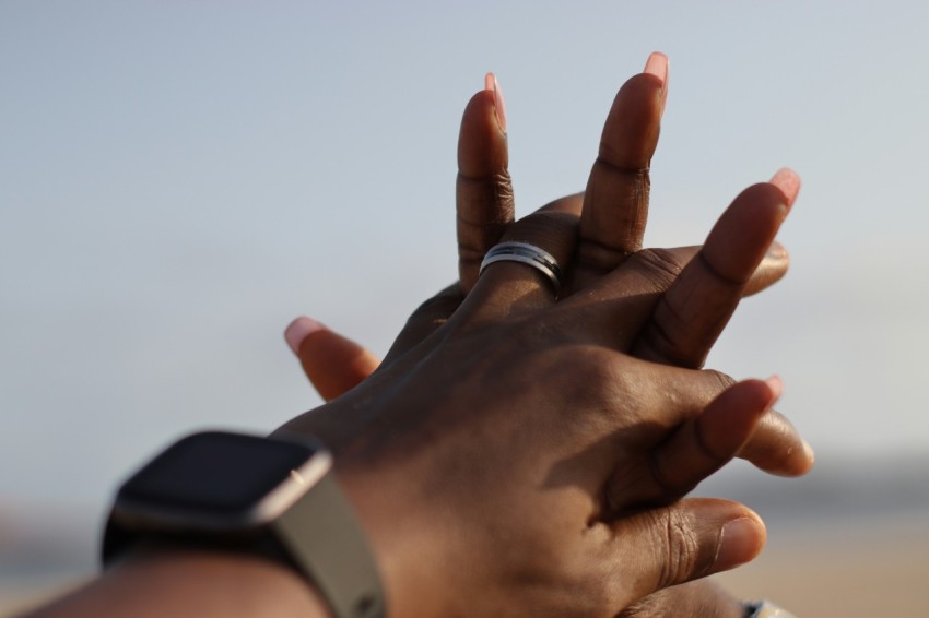 person wearing silver ring and silver ring