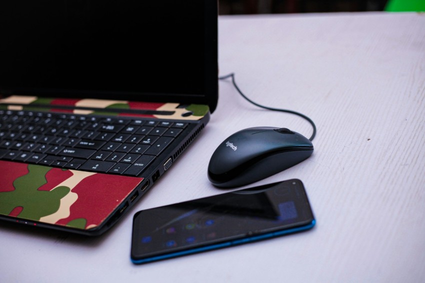 a laptop computer sitting on top of a white table