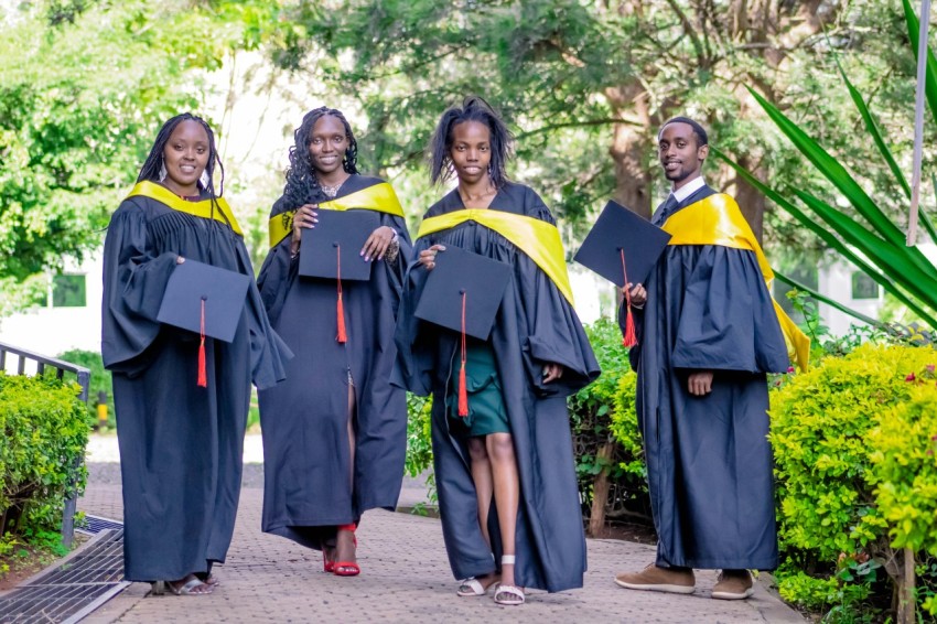 a group of people standing next to each other in graduation gowns