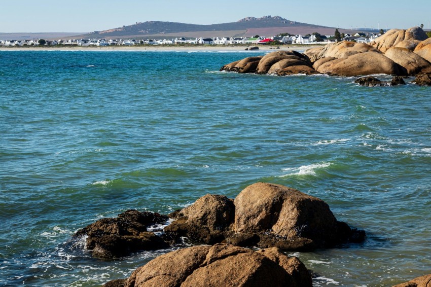 a body of water with rocks in the foreground