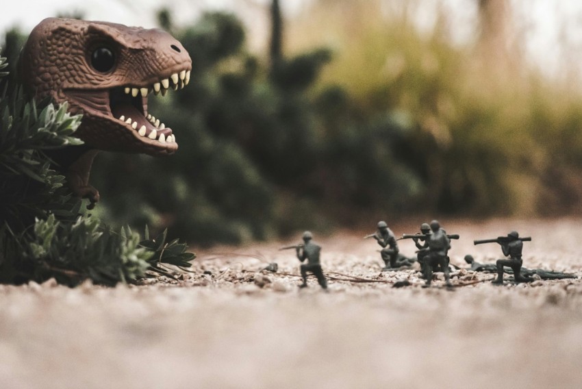 group of soldier near dinosaur miniature