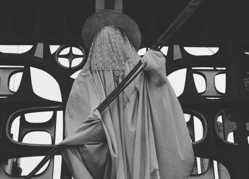 a black and white photo of a statue of a wizard