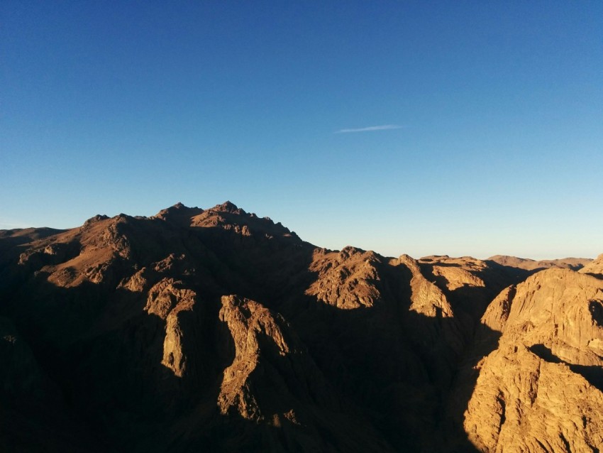 brown rocky mountain under blue sky during daytime