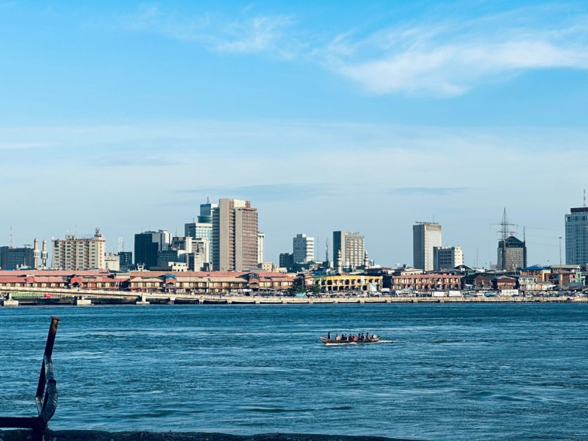 a body of water with a city in the background