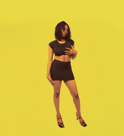 a woman in a black top and a black skirt