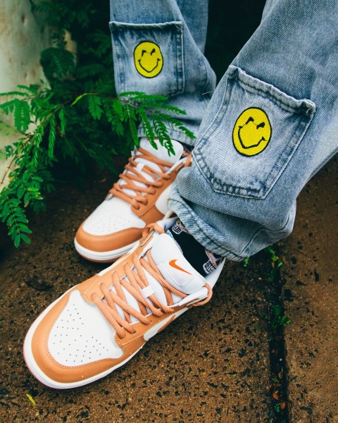 a pair of sneakers with smiley faces painted on them 2oNR3ReEL
