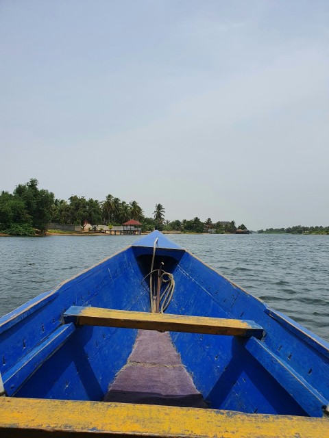 a blue and yellow boat in a body of water