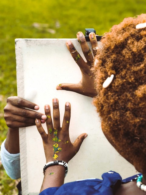 a group of hands holding a piece of paper