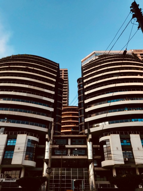 a couple of tall buildings sitting next to each other