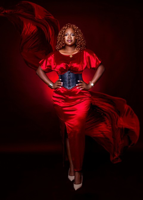 a woman in a red dress posing for a picture