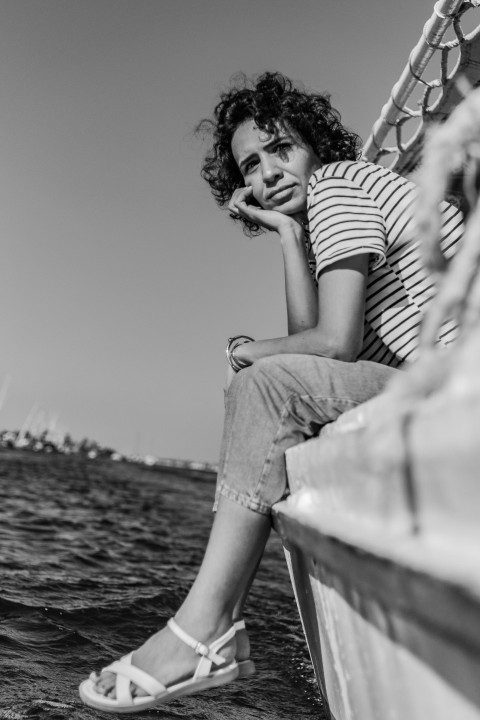 a woman sitting on a boat in the water