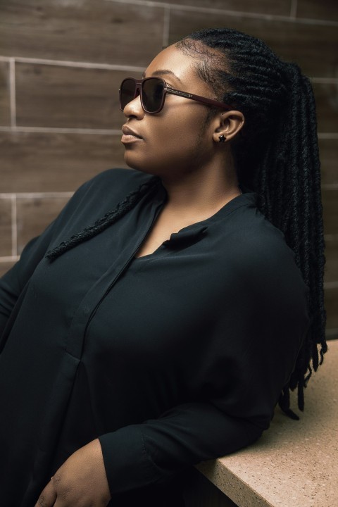 a woman wearing sunglasses and a black shirt ojZix