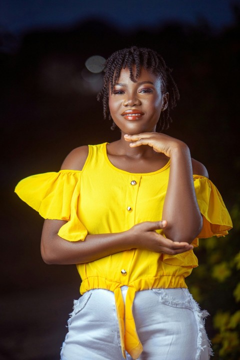 a woman in a yellow top posing for a picture