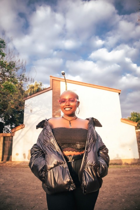 a woman standing in front of a white building