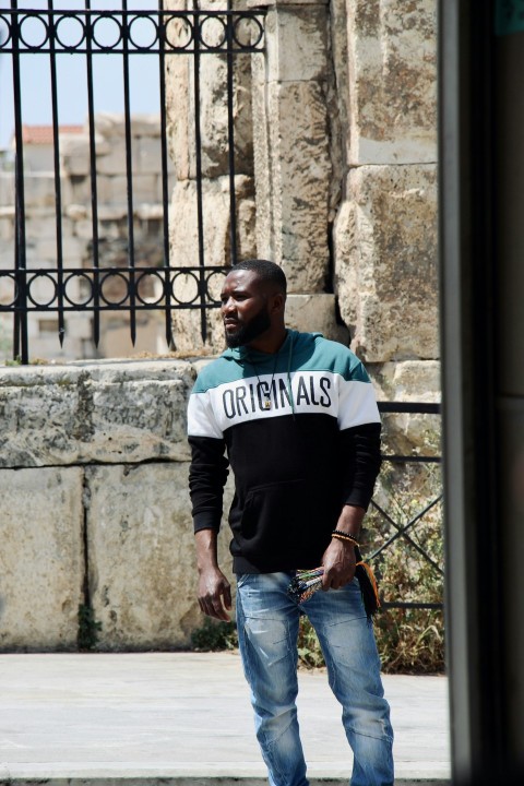 a man in a black shirt is standing on a skateboard