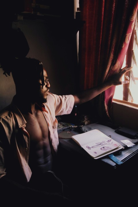 woman in white shirt sitting by the table
