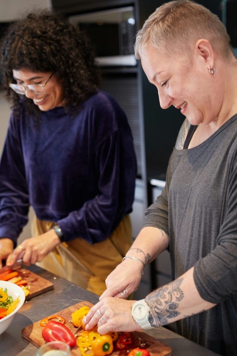 a man and a woman preparing food in a kitchen