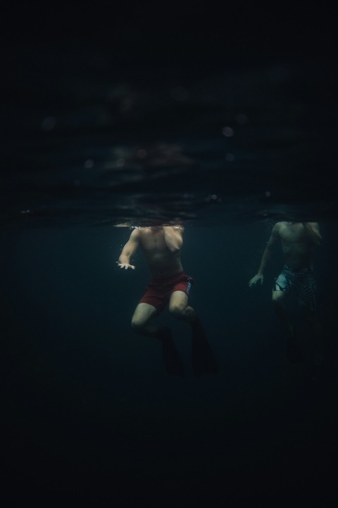 a man swimming in the water with a mask on