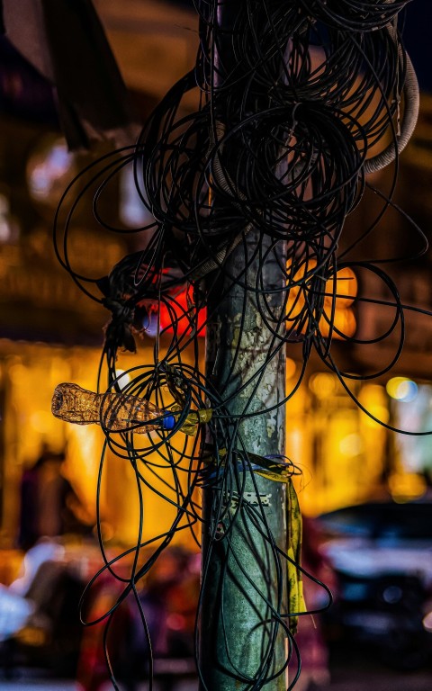 a telephone pole covered in wires and wires