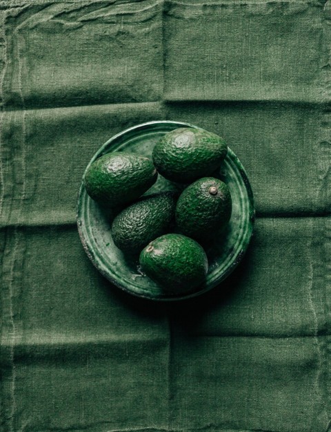 black round fruits in clear glass bowl